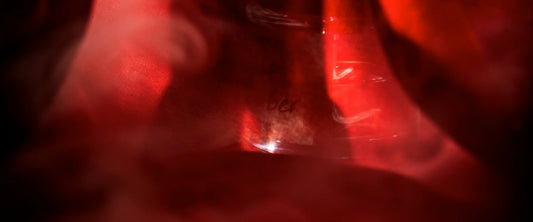 Velvet Ember perfume sample with warm red tones, symbolising quiet strength and confidence.